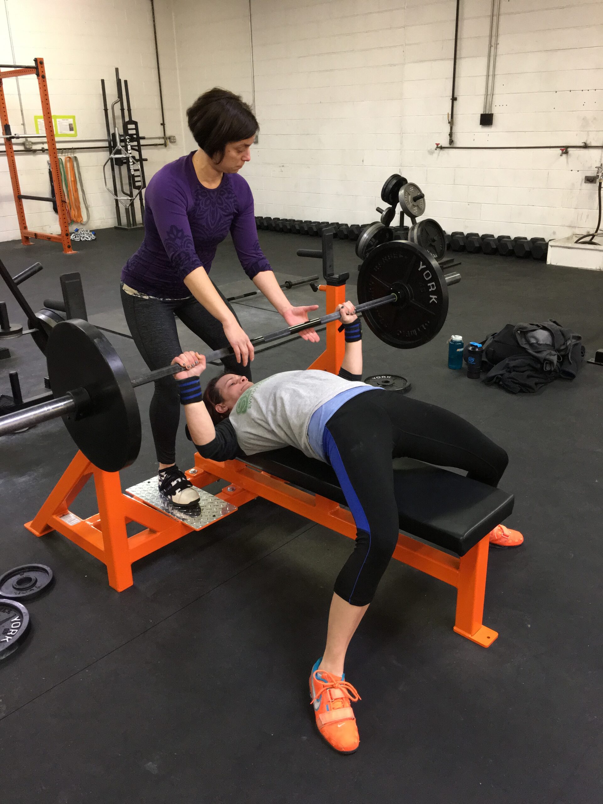 Shera spotting Katie on a bench press